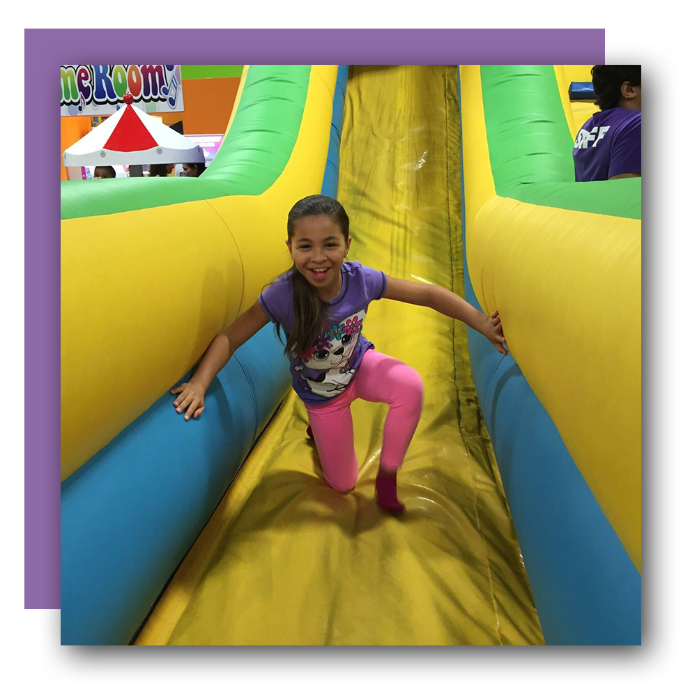 young girl getting off of jumpy castle